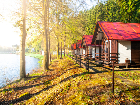 Small wooden forest cottages at the water.の写真素材