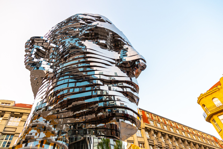 PRAGUE, CZECH REPUBLIC - AUGUST 17, 2018: Statue of Franz Kafka. Glossy metal mechanical sculpture of famous Czech writer. Bust by artist David Cerny. Prague, Czech Republic.のeditorial素材