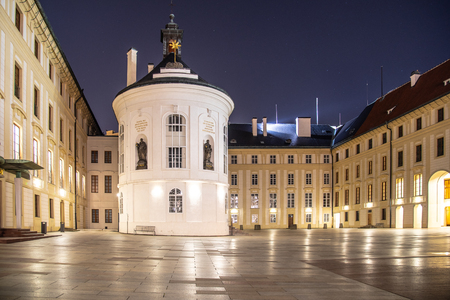 Medieval houses and old drinking fountain in Golden Lane by night, Prague Castle, Czech Republic.の写真素材