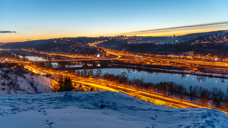 View of Barrandov Bridge over Vltava River in Branik, Prague, Czech Republic. Illuminated roads in cold winter evening.の写真素材