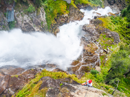 Man climbing on a via ferrata near Stuibenfall, Austriaの写真素材