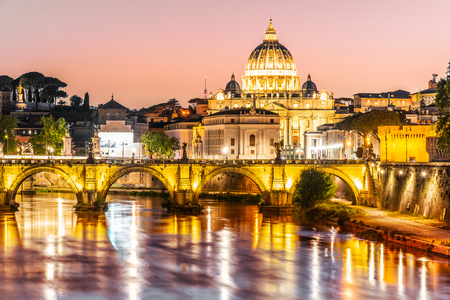 St Peters Basilica in Vatican and Ponte SantAngelo Bridge over Tiber River at dusk. Romantic evening cityscape of Rome, Italy.の写真素材