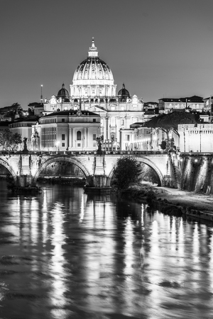 St Peters Basilica in Vatican and Ponte SantAngelo Bridge over Tiber River at dusk. Romantic evening cityscape of Rome, Italy. Black and white image.の写真素材