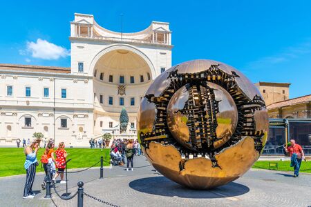 VATICAN CITY - MAY 07, 2018: Sphere within Sphere - bronze sculpture by Italian sculptor Arnaldo Pomodoro. Courtyard of the Pigna of Vatican Museums, Vatican City.のeditorial素材