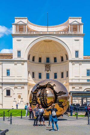 VATICAN CITY - MAY 07, 2018: Sphere within Sphere - bronze sculpture by Italian sculptor Arnaldo Pomodoro. Courtyard of the Pigna of Vatican Museums, Vatican City.のeditorial素材