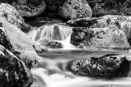 Mountain rocky river flow. Long exposure shot. Black and white image.の写真素材