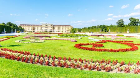 VIENNA, AUSTRIA - 23 JULY, 2019: Schonbrunn Palace, German: Schloss Schonbrunn, and Great Parterre - French Garden with beautiful flower beds, Vienna, Austriaのeditorial素材