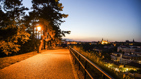 Walkway on Vysehrad fortification walls illuminated by street lamps by night. Prague, Czech...