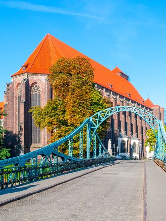 Tumski Bridge in Wroclaw with a view of St. Mary Church, Poland.の写真素材