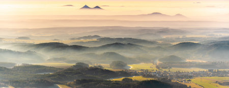 Bezdez twin mountains rising from the mist. Weather temperature inversion, Czech Republic.