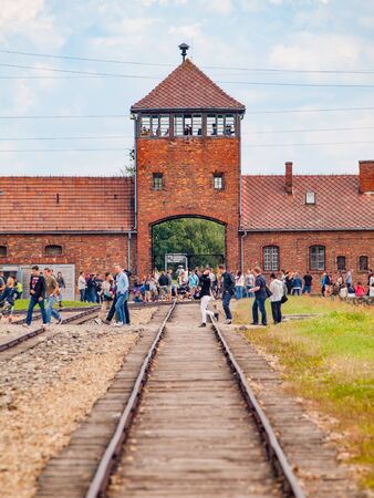 OSWIECIM, POLAND - AUGUST 17, 2014: Main gate to concentration camp in Oswiecim-Brzezinka, Auschwitz-Birkenau, Poland.のeditorial素材