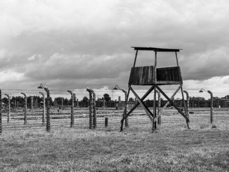 OSWIECIM, POLAND - AUGUST 17, 2014: Simple wooden guard post in concentration camp, Auschwitz - Birkenau, Poland. Black and white image.のeditorial素材