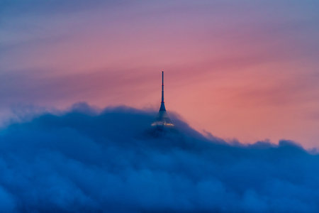Jested tower partly hidden in the clouds. Dramatic evening atmosphere. Liberec, Czech Republic.