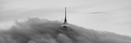 Jested tower partly hidden in the clouds. Dramatic evening atmosphere. Liberec, Czech Republic. Black and white image.の写真素材