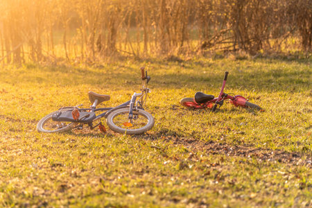 Two kids bikes abandoned on the ground. Evokes lost or kidnapped children. Crime or thriller theme.