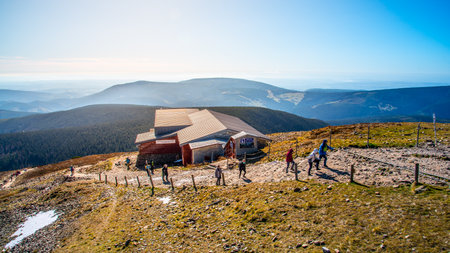 SNEZKA, GIANT MOUNTAINS - OCTOBER 12, 2019: Tourists hiking in Giant Mountains, Czech: Krkonose. View from Snezka - the highest mountain. Czech Republic and Poland.のeditorial素材