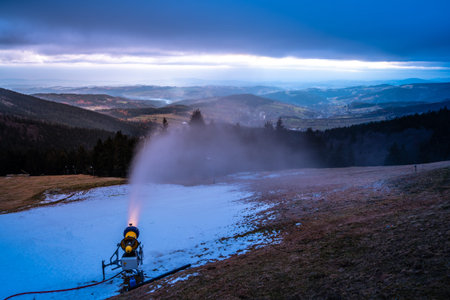 First winter snow making. Snow cannon at evening time. Rokytnice nad Jizerou, Giant Mountains, Czech...