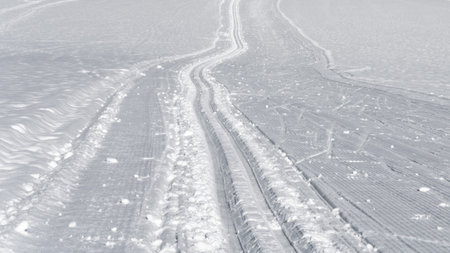 Cross country skiing track. Sunny day in mountains. Outdoor leisure activity.