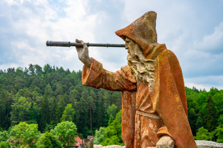 SLOUP V CECHACH, CZECH REPUBLIC - JUNE 26, 2020: Statue of old bearded hermit with telescope on the lookout platform of Sloup v Cechach castle ruins, Czech Republicのeditorial素材