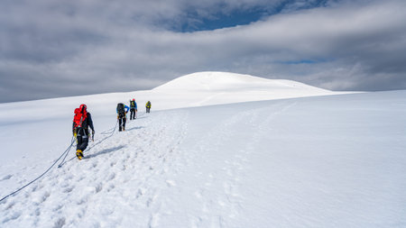 Group of mountaineers on a rope. Summer glacier trekking on Grossvenediger Mountain, Hohe Tauern...
