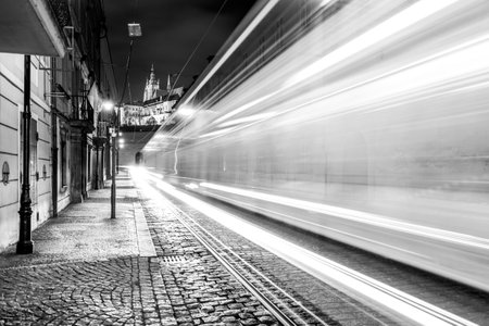 Night tram in Prague. Motion blurred tram in Letenska Street, Lesser Town of Prague, Czech Republic. Black and white image.の写真素材