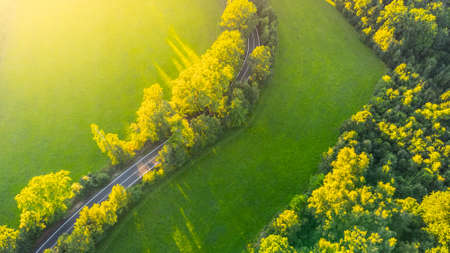 Asphalt road in rural landscape from aboveの写真素材