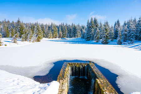 Ice covered water reservoir in Jizera Mountainsの写真素材