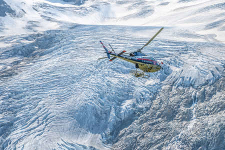 MATREI IN OSTTIROL, AUSTRIA - AUGUST 21, 2021: Austrian Police Air Support Helicopter - Eurocopter AS 350B Ecureuil. Montain glacier on background. Austriaのeditorial素材