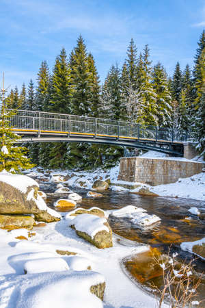 Pedestrian broder bridge over Jizera River in winterの写真素材