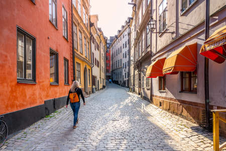 Young woman in the street of Stockholm Old Townの写真素材
