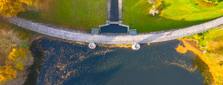 Fojtka water reservoir surrounded by vibrant colored forest at autumn time. Aerial view from drone.