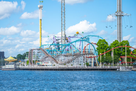 Amusement park Grona Lund with roller coasters and adrenaline-fueled attractions on a sunny summer day. Stockholm, Swedenの写真素材