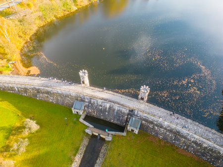 Fojtka water reservoir surrounded by vibrant colored forest at autumn time. Aerial view from drone.の写真素材