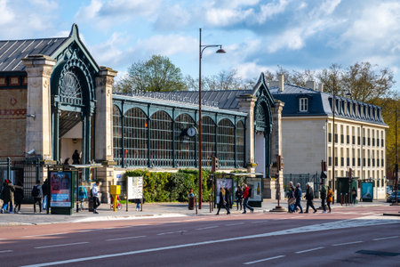 VERSAILLES, FRANCE - APRIL 15, 2023: Versailles Chateau Rive Gauche train station. Vintage building and people in the street. Versailles near Paris, France.のeditorial素材