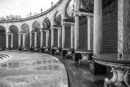 Pool and statue of Fame in Colonnade Grove in the Gardens of Versailles, Chateau Versailles near...