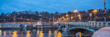 Cech Bridge over Vltava River and Pendulum in Letna Gardens in the evening. Prague, Czechia
