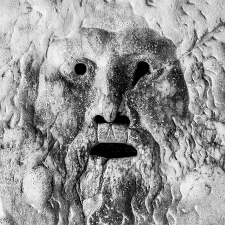 A close-up of the Mouth of Truth, Italian: Bocca della Verita, in Rome, a marble sculpture with a large gaping mouth. This famous artifact is located in the Santa Maria in Cosmedin church.の写真素材