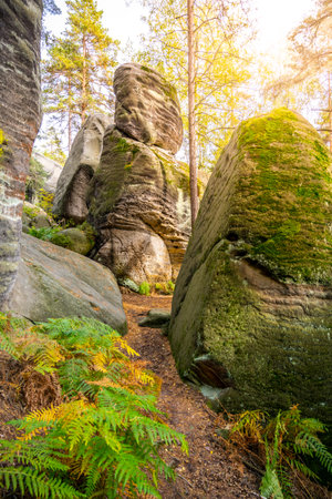 Wander through the stunning Besedice Rocks during autumn, where vibrant foliage contrasts with towering rock formations and serene paths, inviting adventure and tranquility in the Bohemian Paradise.の写真素材