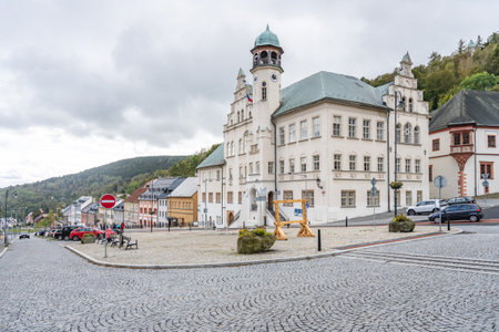 Jachymovs town hall stands majestically, showcasing its architectural beauty against a backdrop of rolling hills. Cobblestone streets invite exploration in this charming Czech town.の写真素材