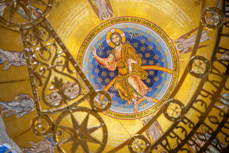 The interior of the Church of Saint Sava features an intricate dome adorned with gold and colorful mosaics depicting Christ.の写真素材