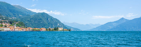 Visitors enjoy the serene beauty of Lake Como, surrounded by majestic mountains and charming villages. The clear blue waters reflect the vibrant landscape, evoking a sense of peace and relaxation.の写真素材