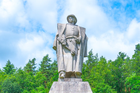 The monument of Jan Zizka stands proudly in Trocnov, honoring the prominent Hussite military leader at his birthplace, surrounded by lush greenery and a bright sky.の写真素材