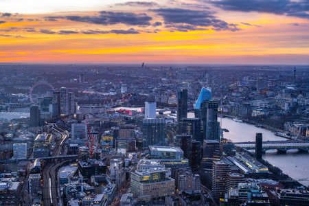 Captivating sunset unfolds over London, showcasing the skyline from The Shard. The vibrant colors paint the sky as the city winds down into twilight, offering a breathtaking perspective.の写真素材