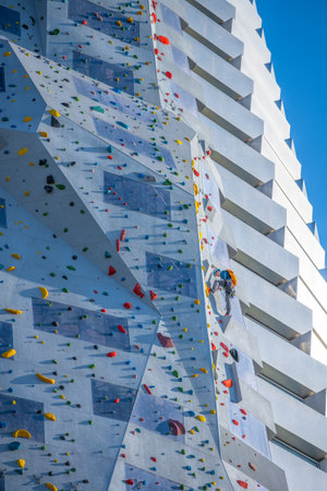 Adventurers climb the Amager Bakke climbing wall in Copenhagen, Denmark. This impressive structure reaches great heights, attracting climbers eager to challenge themselves.の写真素材