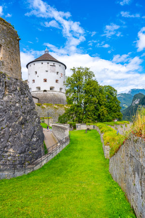 Historic Kufstein Fortress stands majestically in Tyrol, Austria, surrounded by lush greenery and dramatic skies, inviting visitors to discover its rich history and panoramic views of the Alps.の写真素材