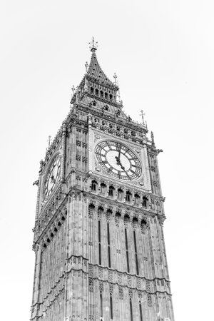 Big Ben, an iconic symbol of London, towers against a clear sky. Its intricate design showcases the...