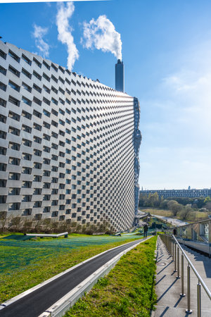 Copenhill, located in Copenhagen, features a unique architectural design with a recreation area. The facility produces energy while offering visitors outdoor experiences amidst nature.の写真素材