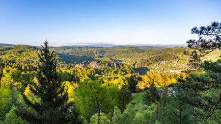 Enjoy breathtaking sights from Pantheon Lookout in Bohemian Paradise, with lush greenery and Krkonose Mountains creating a stunning backdrop at sunset.の写真素材