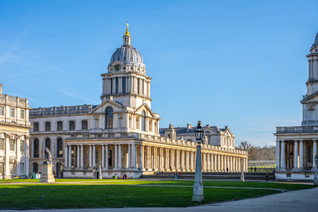 Historical buildings at Greenwich Campus in London showcase stunning architecture under clear blue skies.の写真素材