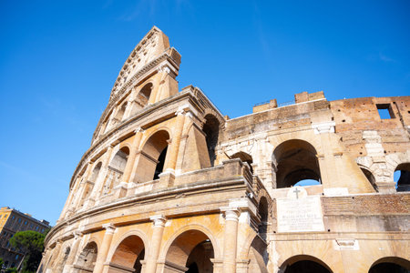 Visitors admire the majestic Colosseum in Rome, Italy, marveling at its ancient architecture and...